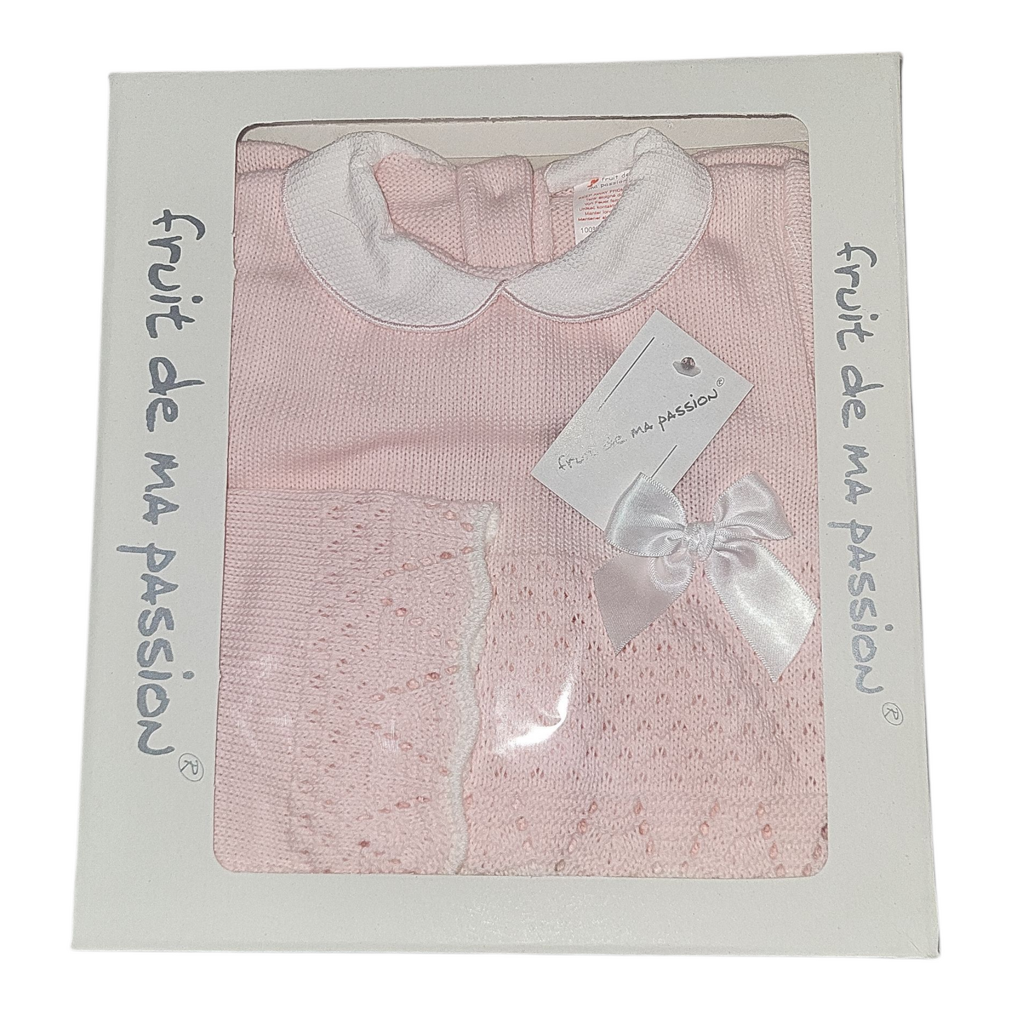 Pink baby outfit with white collar in packaging labeled 'fruit de ma passion'.