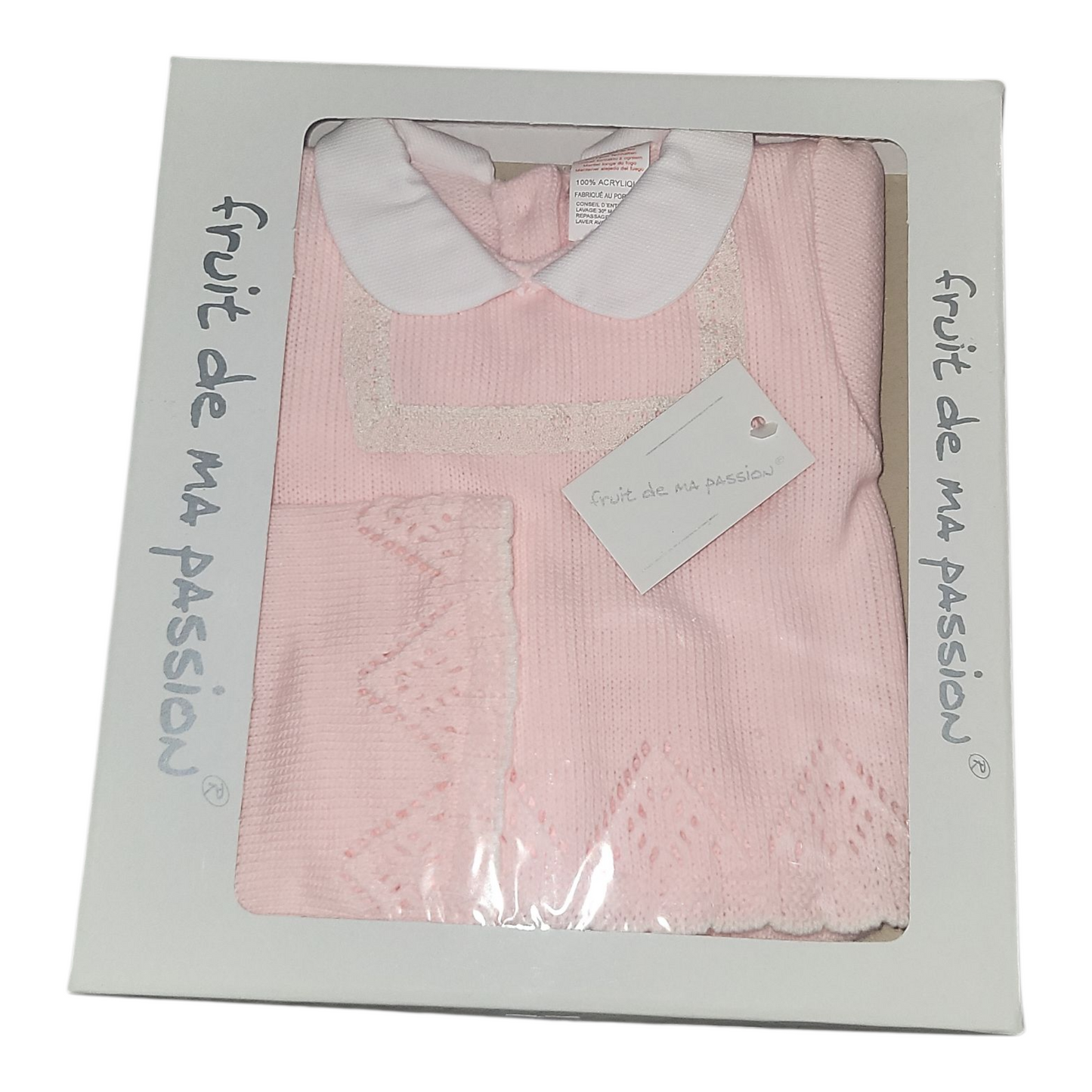 Pink baby dress with white collar in packaging labeled 'fruit de ma passion'.