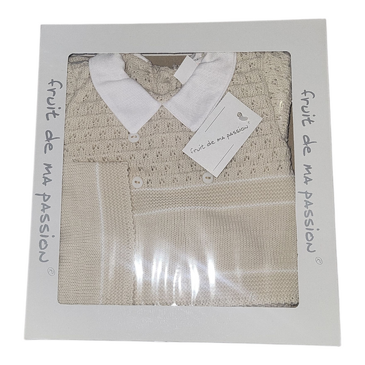 Folded beige knitted garment with white collar in packaging labeled 'fruit de ma passion'.