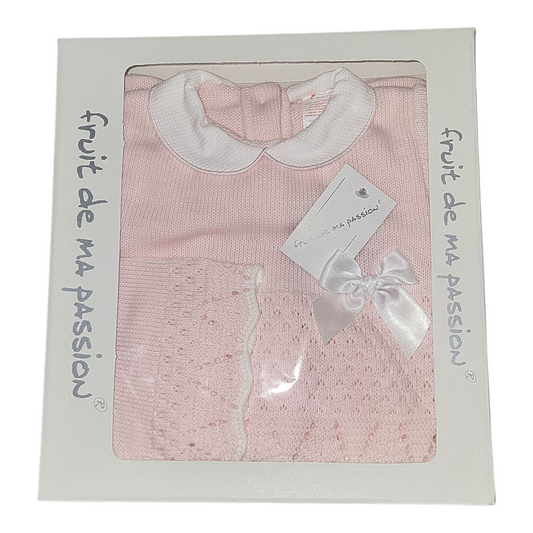 Pink baby outfit with white collar in packaging labeled 'fruit de ma passion'.