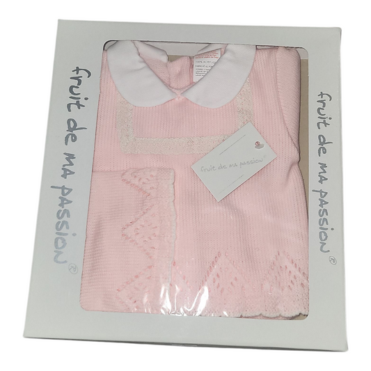 Pink baby dress with white collar in packaging labeled 'fruit de ma passion'.