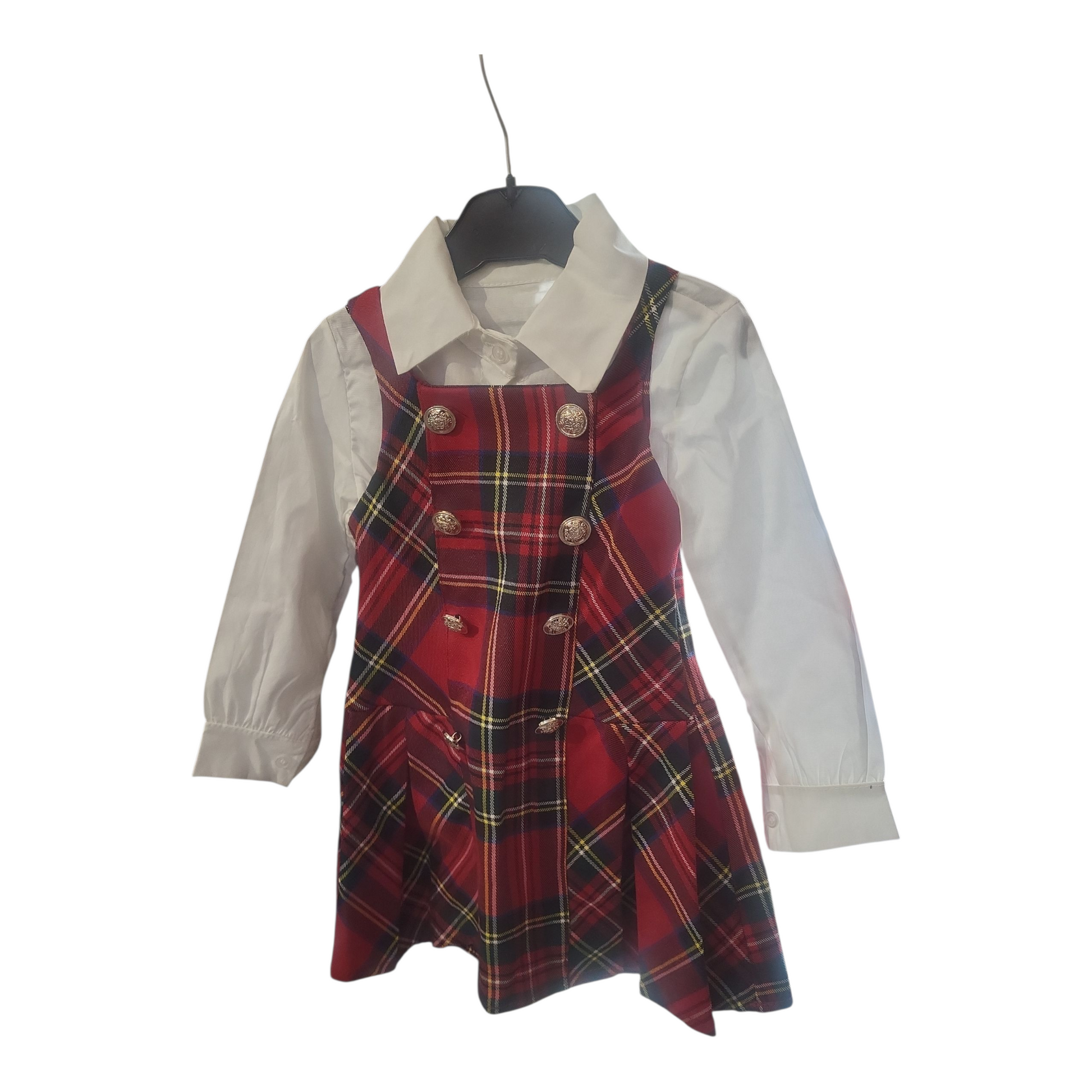 Red tartan dress with gold buttons over a white blouse